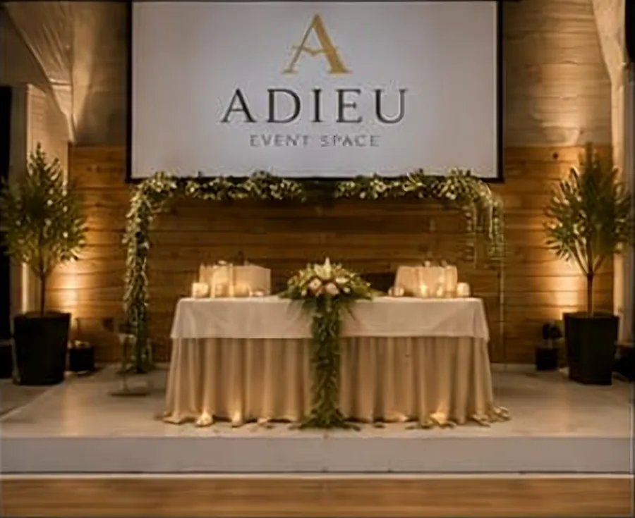 Head table and sweetheart setup on the stage at Adieu Event Space