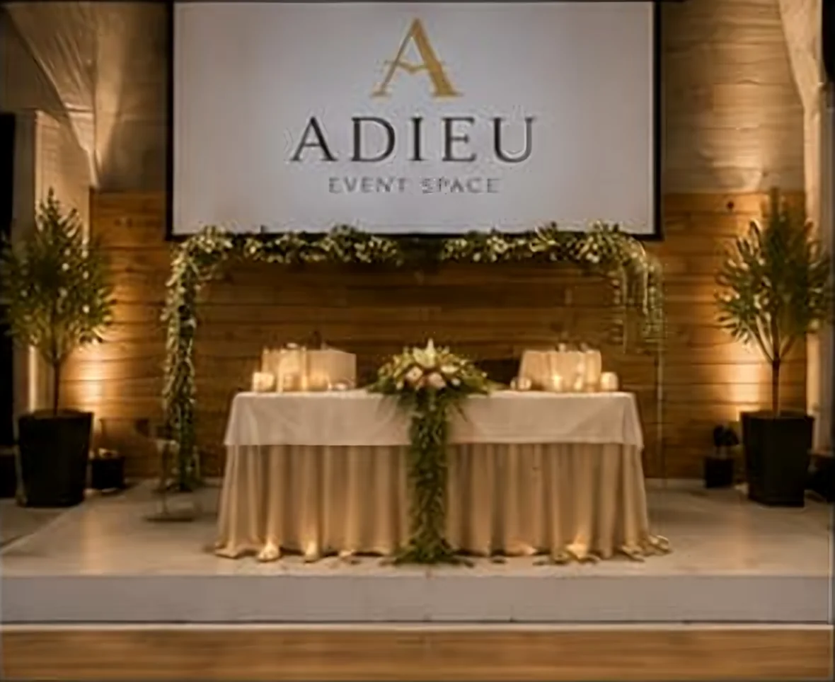 Head table and sweetheart setup on the stage at Adieu Event Space