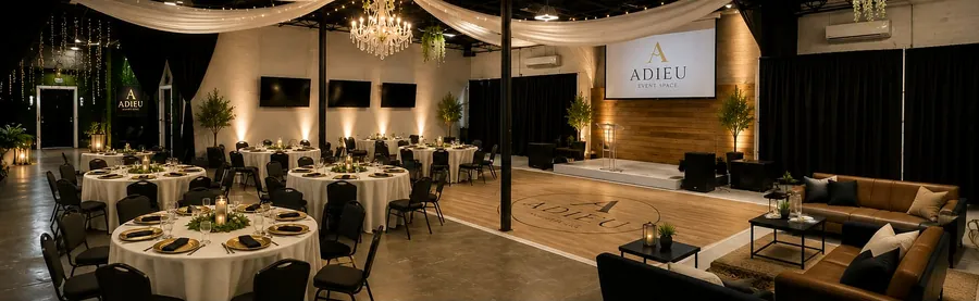 Banquet setup at Adieu Event Space in EaDO Houston with round tables, wood dance floor, stage and chandelier