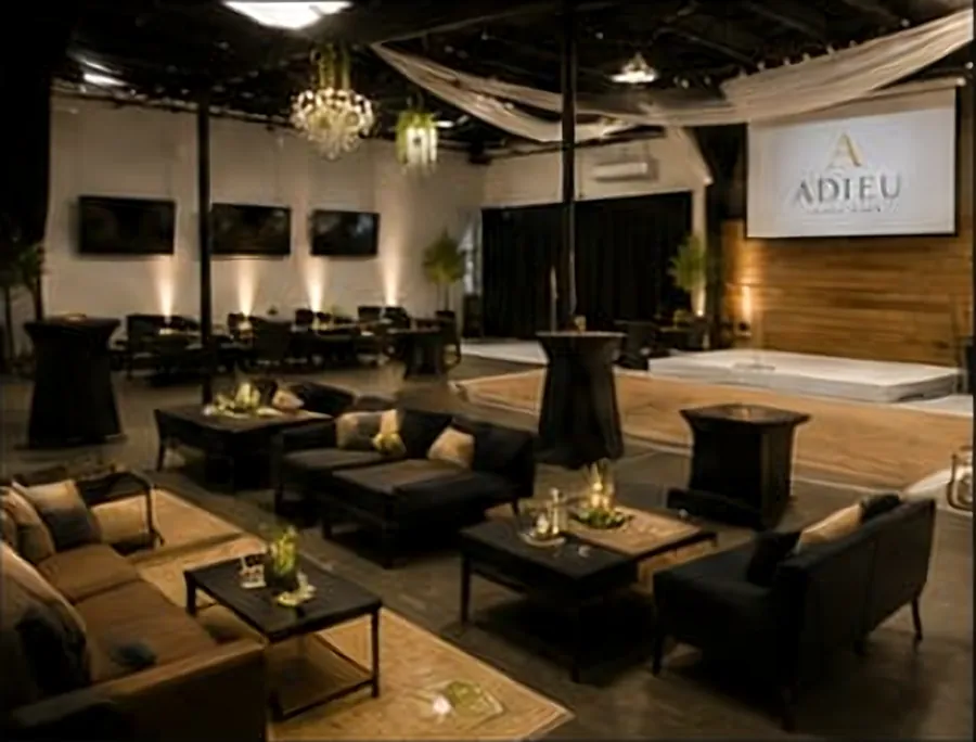 Lounge and watch party layout with leather seating and TVs at Adieu Event Space